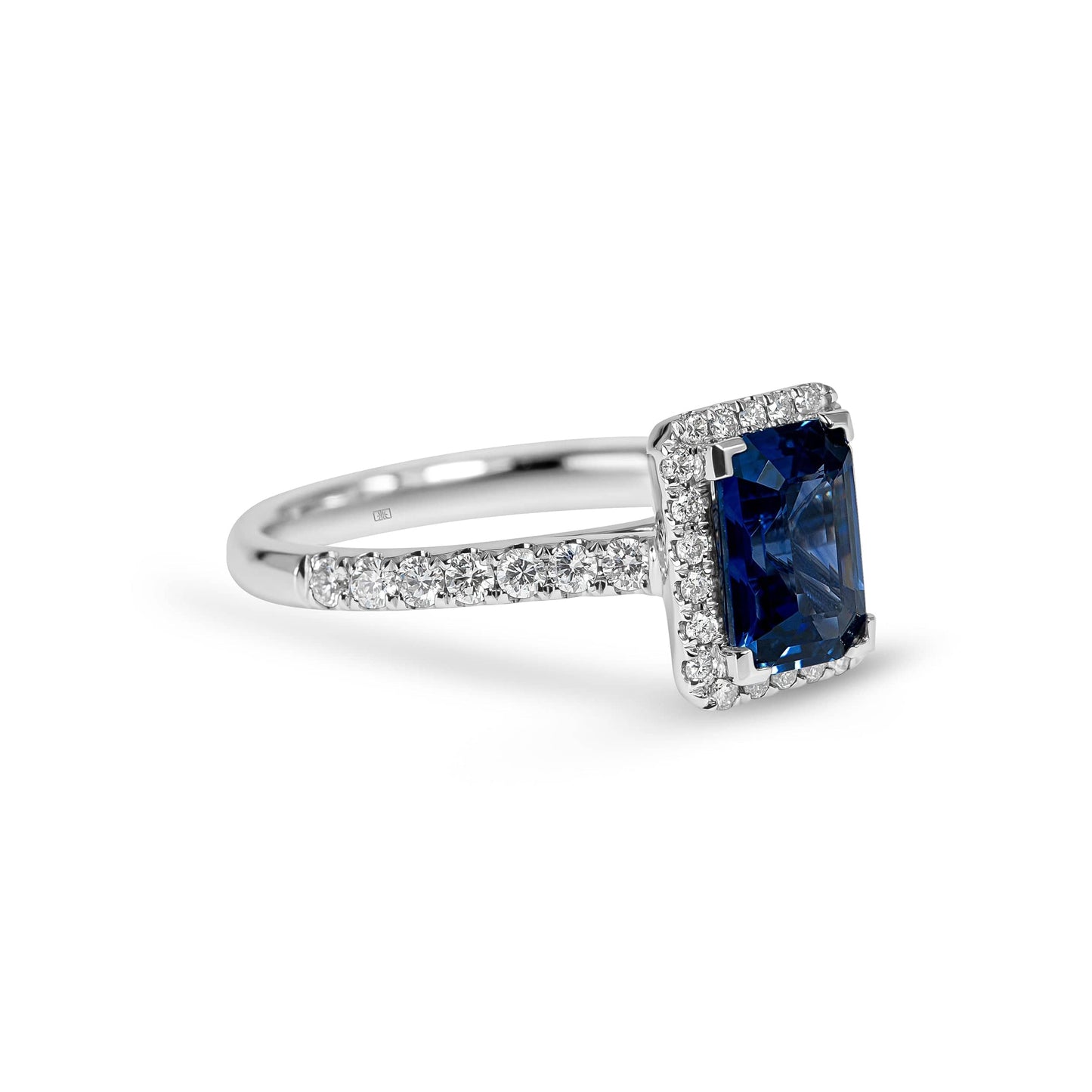 Emerald Cut Sapphire with Sidestones & Halo Diamond Ring